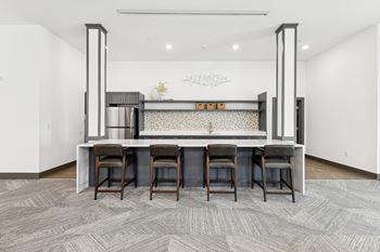 Kitchen with a bar and chairs in a room with a dining table